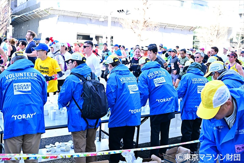 Volunteer staff wearing official clothing made from &+™ fiber